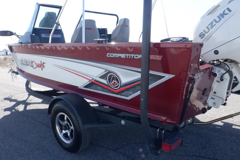 Slide: The Image of 2020 Alumacraft Competitor 165 Sport boat with Suzuki outboard motor, red and silver design. - 6