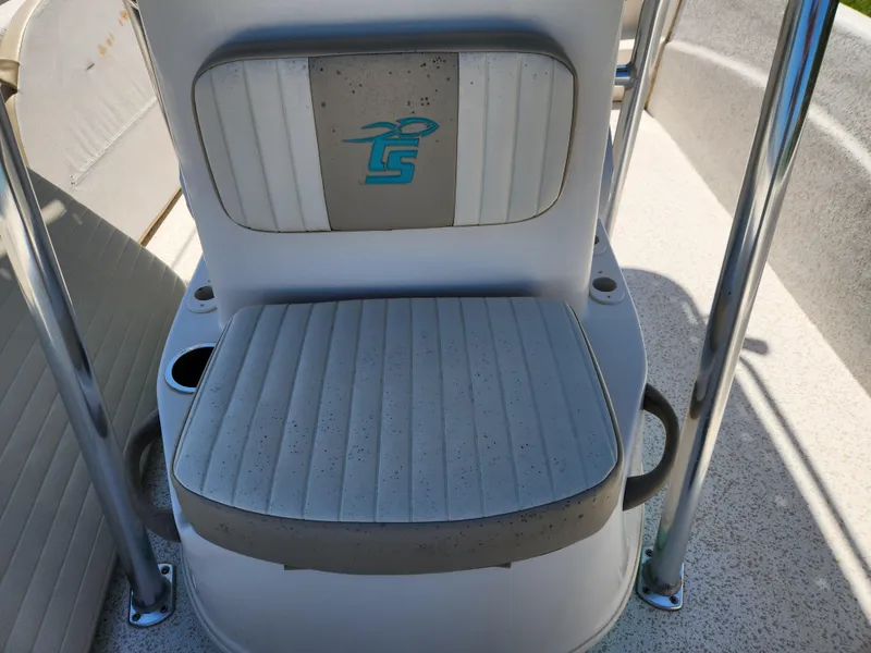 Slide: The Image of 2018 Carolina Skiff 218 DLV boat seat with logo and cup holder. - 10