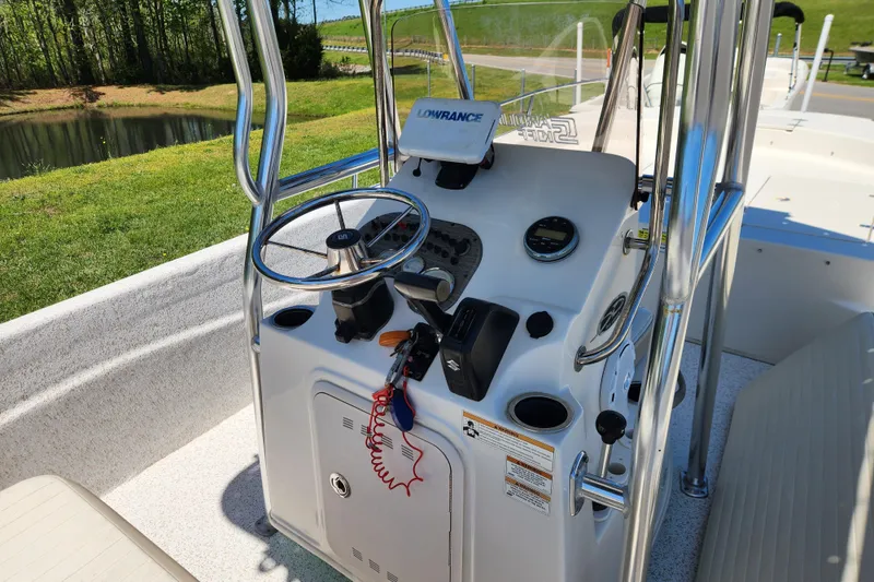 Slide: The Image of 2018 Carolina Skiff 218 DLV boat console with steering wheel and navigation equipment. - 11