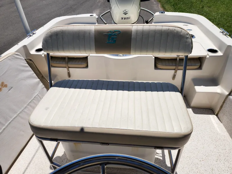 Slide: The Image of 2018 Carolina Skiff 218 DLV boat interior with cushioned seating and steering wheel. - 12