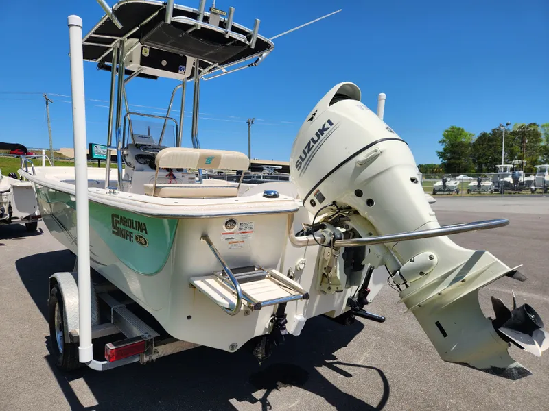 Slide: The Image of 2018 Carolina Skiff 218 DLV boat with Suzuki outboard motor on trailer. - 4