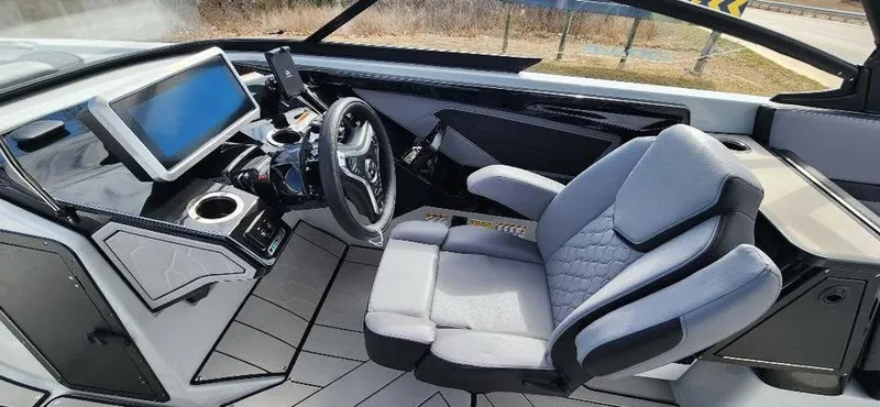 Slide: The Image of 2025 Yamaha Boats 255XD cockpit with modern dashboard and comfortable seating. - 10