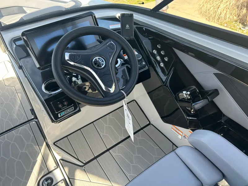 Slide: The Image of 2025 Yamaha Boats 255XD cockpit with modern steering wheel and control panel. - 11