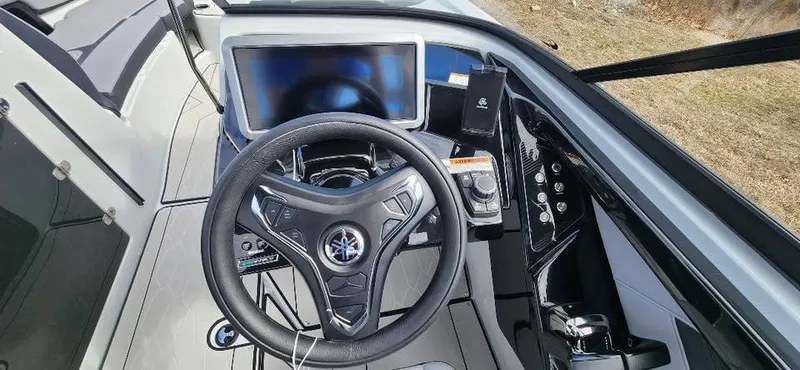 Slide: The Image of 2025 Yamaha Boats 255XD dashboard with steering wheel and digital display. - 12