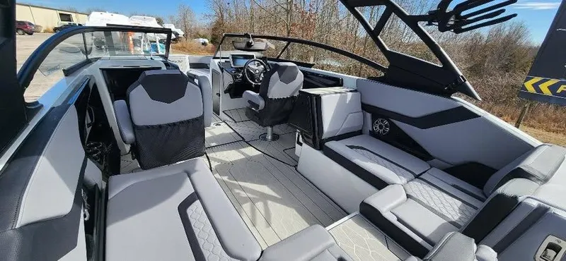 Slide: The Image of 2025 Yamaha Boats 255XD interior with modern seating and steering, showcasing luxury design. - 8
