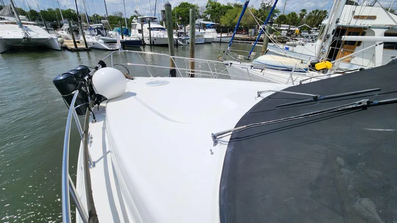 Slide: The Image of 2002 Cruisers 5000 yacht docked at a marina, surrounded by other boats. - 11
