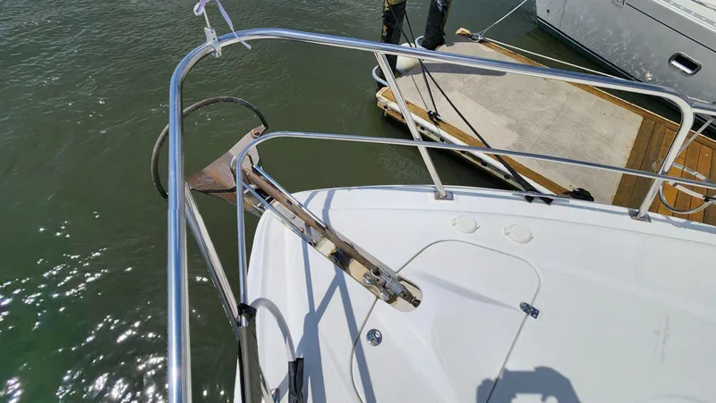 Slide: The Image of Bow of a 2002 Cruisers 5000 yacht with anchor and railing, docked at marina. - 12