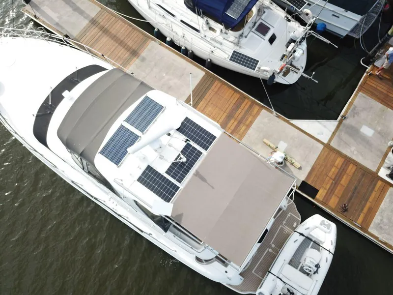 Slide: The Image of Aerial view of 2002 Cruisers 5000 yacht with solar panels docked at marina. - 16