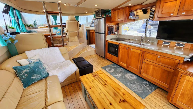 Slide: The Image of Luxurious 2002 Cruisers 5000 yacht interior with kitchen, seating, and modern amenities. - 18