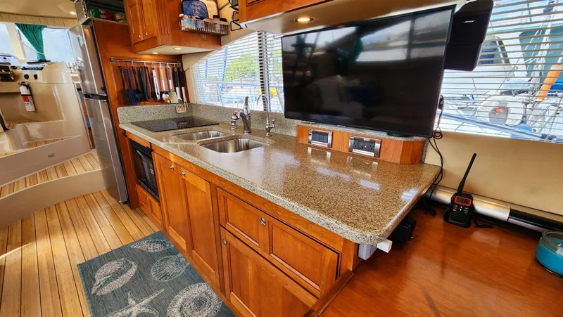 Slide: The Image of Luxurious 2002 Cruisers 5000 yacht kitchen with granite countertops and modern appliances. - 22