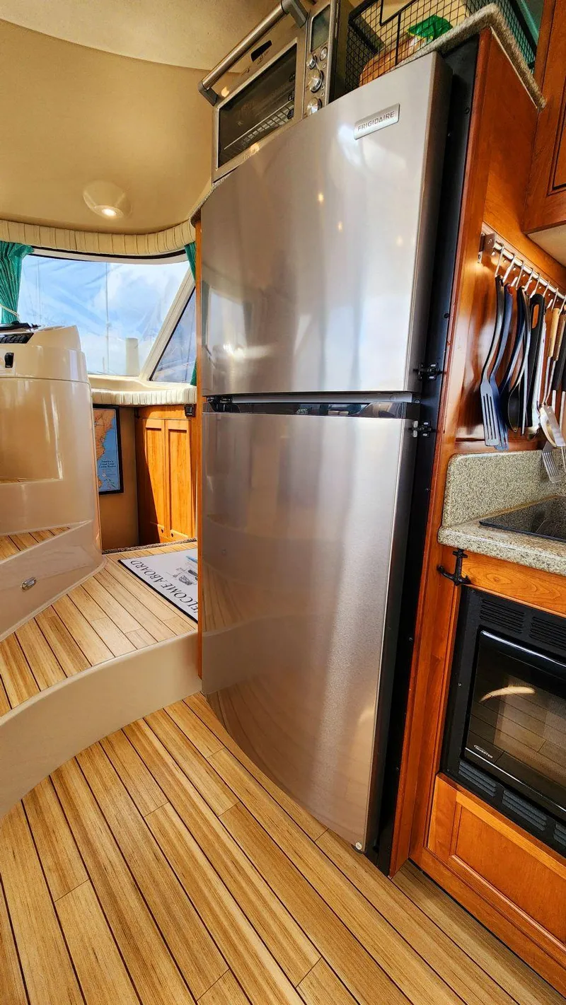 Slide: The Image of Modern kitchen interior of 2002 Cruisers 5000 yacht with stainless steel appliances. - 25