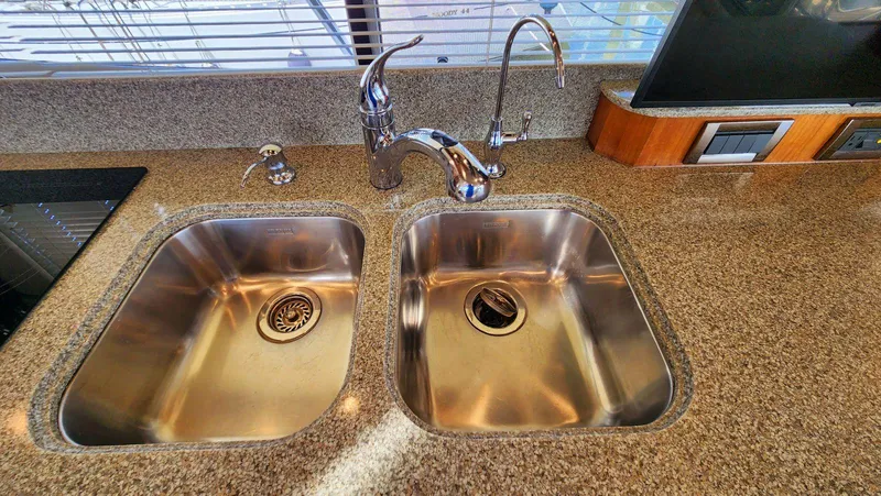 Slide: The Image of Double stainless steel sink on granite countertop in 2002 Cruisers 5000 yacht kitchen. - 26