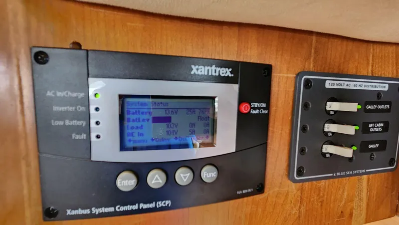 Slide: The Image of Xantrex control panel and Blue Sea Systems distribution panel on 2002 Cruisers 5000 yacht. - 29
