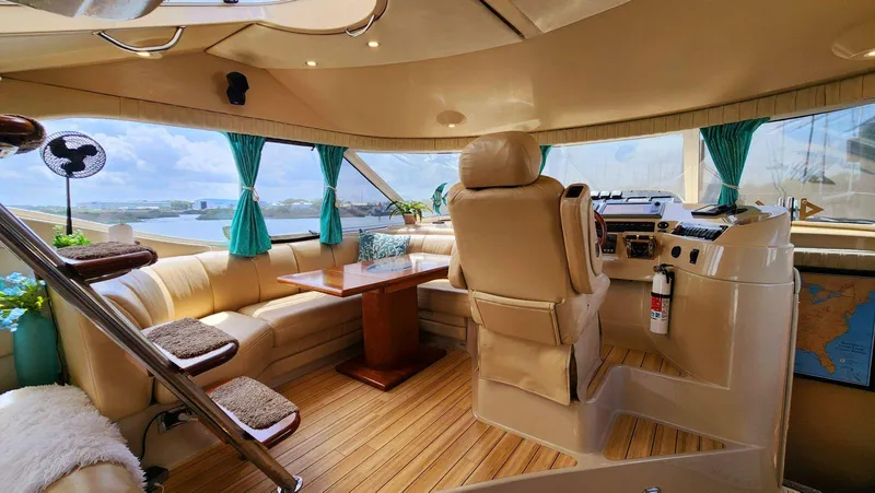 Slide: The Image of Luxurious 2002 Cruisers 5000 yacht interior with leather seating and panoramic windows. - 32