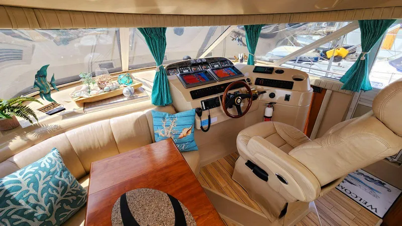 Slide: The Image of Luxurious 2002 Cruisers 5000 yacht interior with helm, leather seating, and nautical decor. - 33
