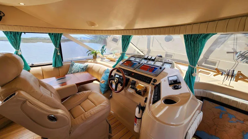 Slide: The Image of Luxurious 2002 Cruisers 5000 yacht interior with leather seating and advanced navigation controls. - 34