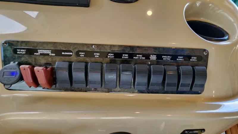 Slide: The Image of Control panel of a 2002 Cruisers 5000 boat with labeled switches and outlets. - 38