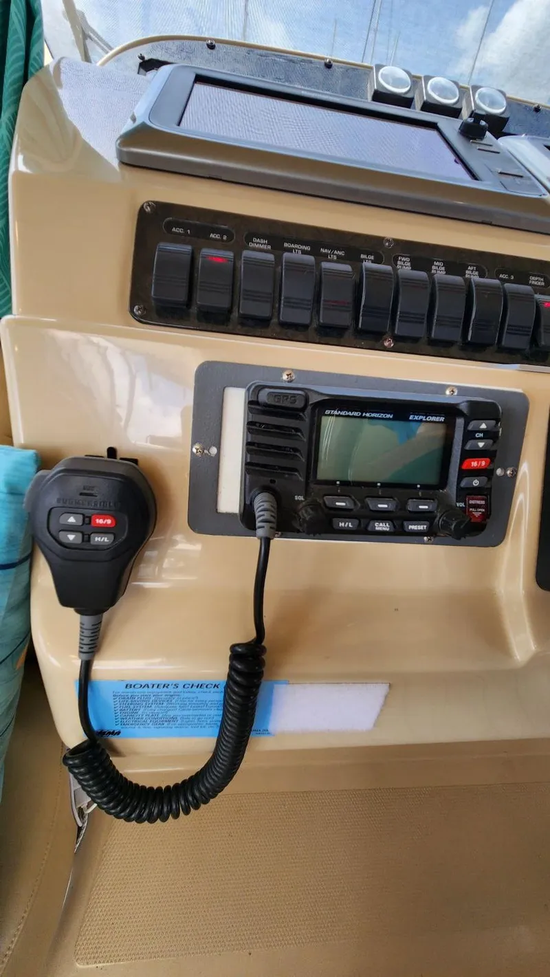 Slide: The Image of Control panel of a 2002 Cruisers 5000 boat with radio and switches. - 43