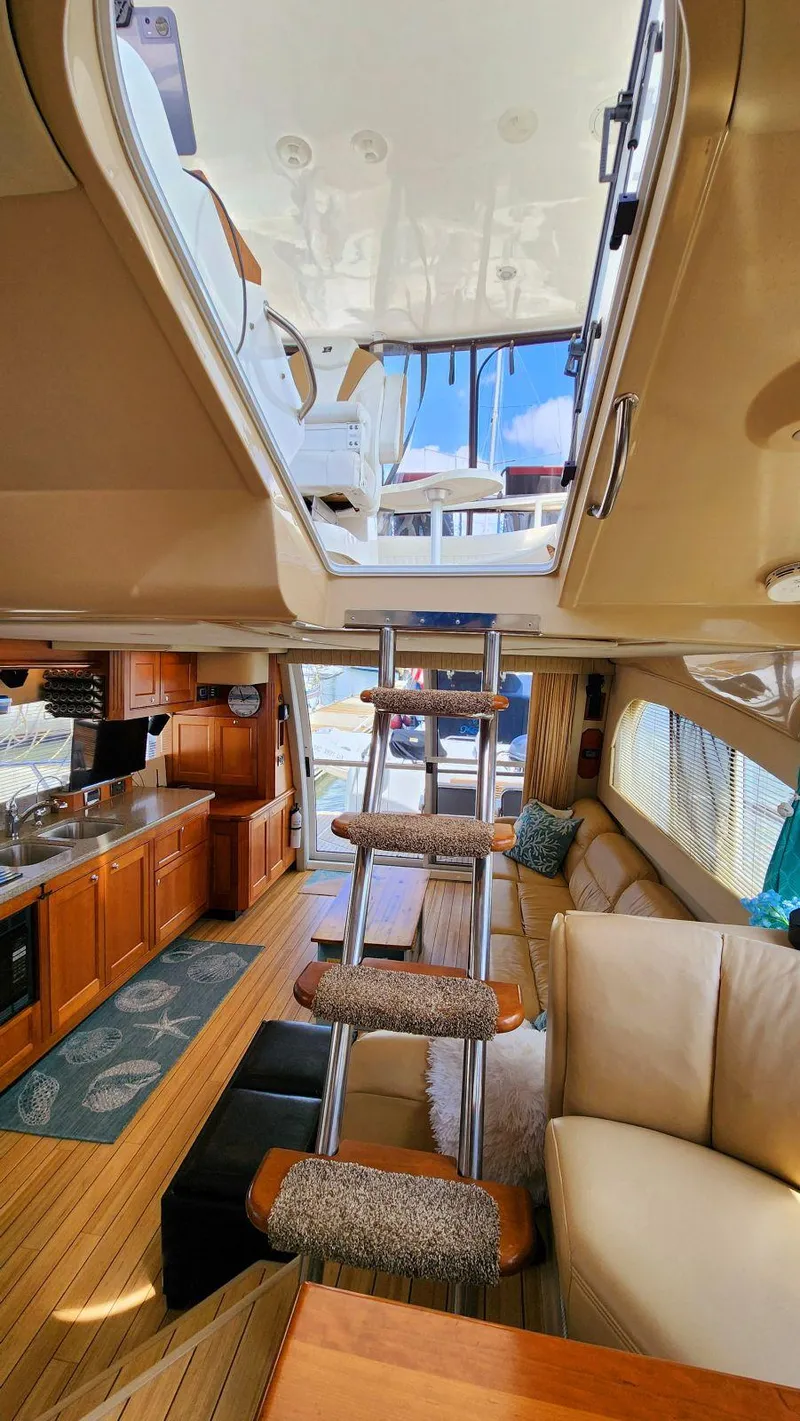 Slide: The Image of Interior of 2002 Cruisers 5000 yacht with modern kitchen and cozy seating area. - 44