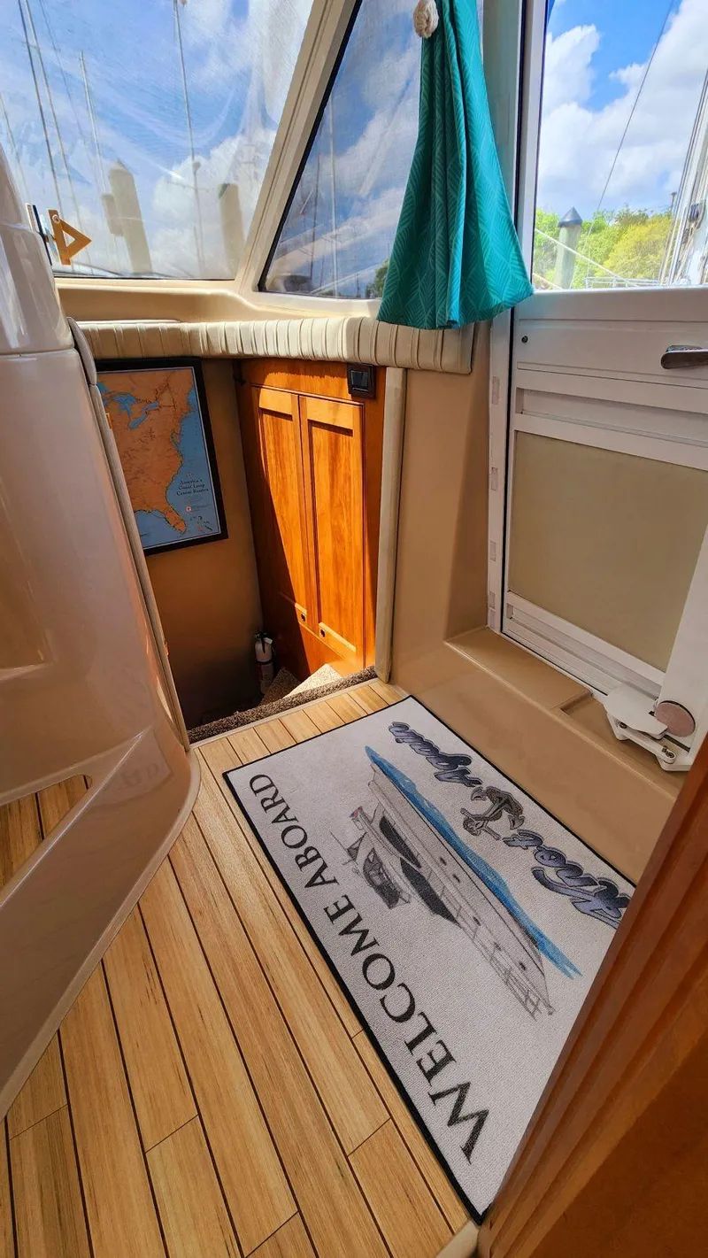 Slide: The Image of Interior of 2002 Cruisers 5000 yacht with welcome mat and wooden flooring. - 45