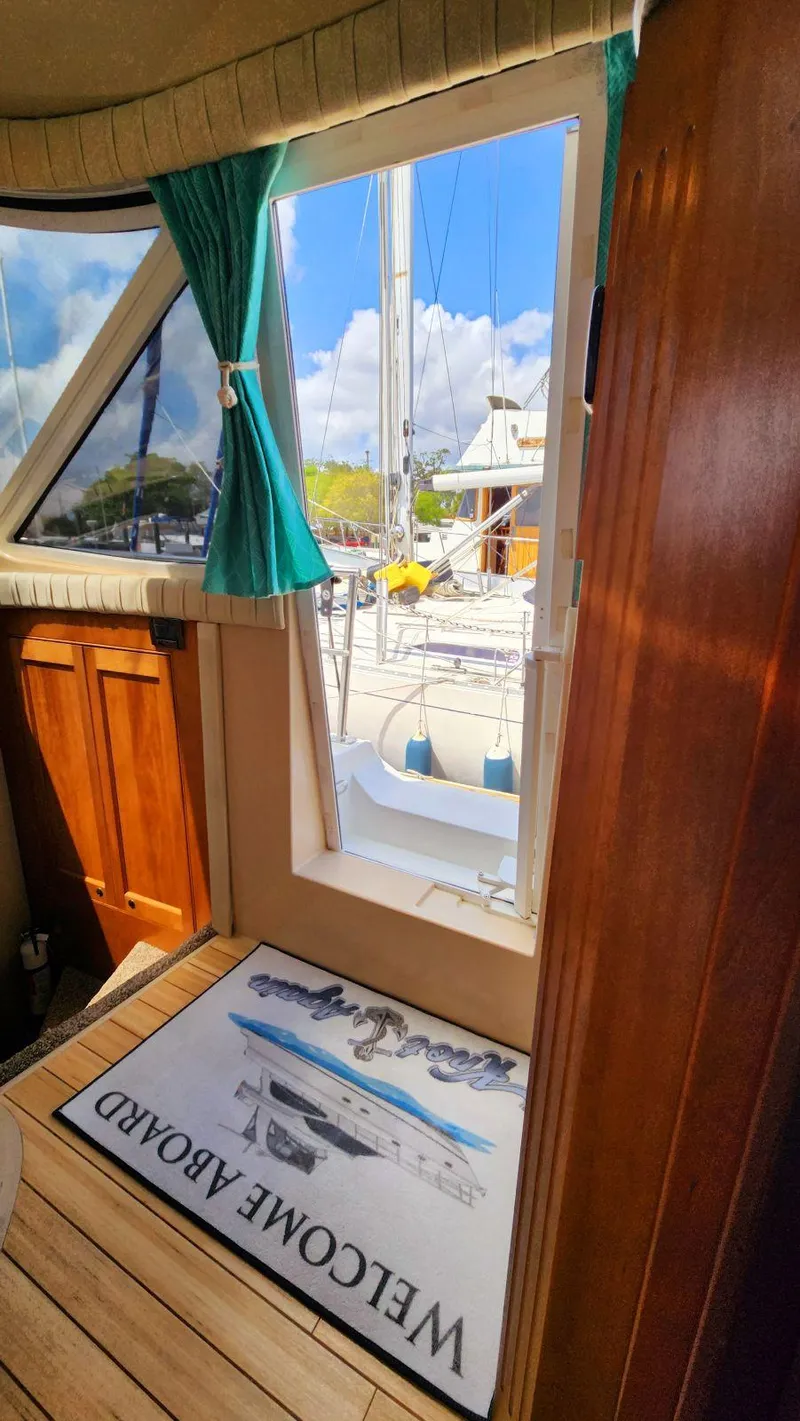 Slide: The Image of Interior view of 2002 Cruisers 5000 yacht with welcome mat and open door to deck. - 46