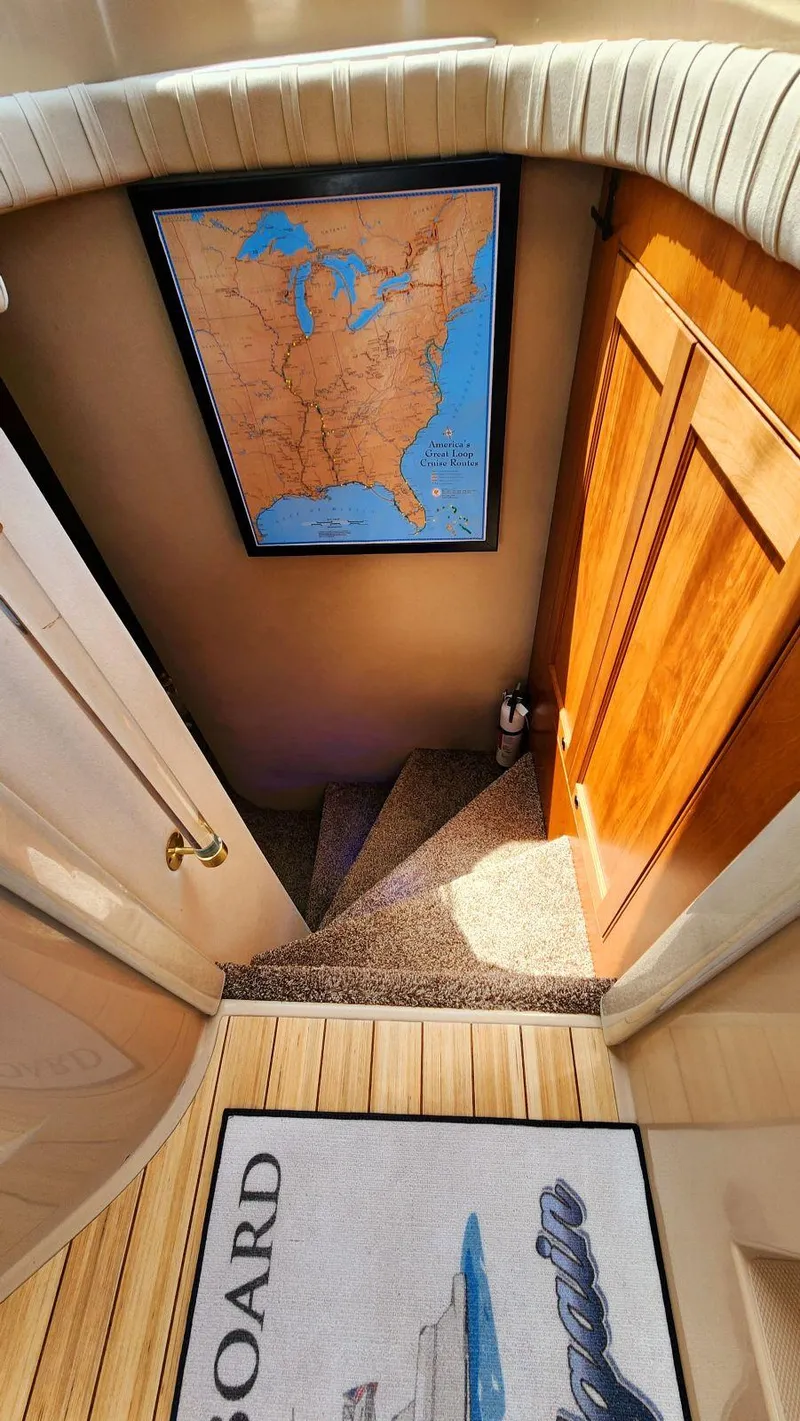 Slide: The Image of Staircase in 2002 Cruisers 5000 yacht with map and wooden door. - 47
