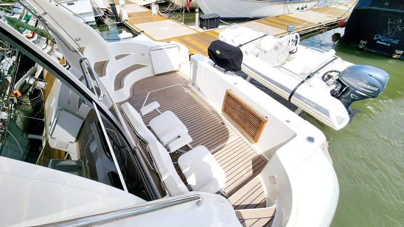 Slide: The Image of Luxurious 2002 Cruisers 5000 yacht with spacious deck at marina. - 8