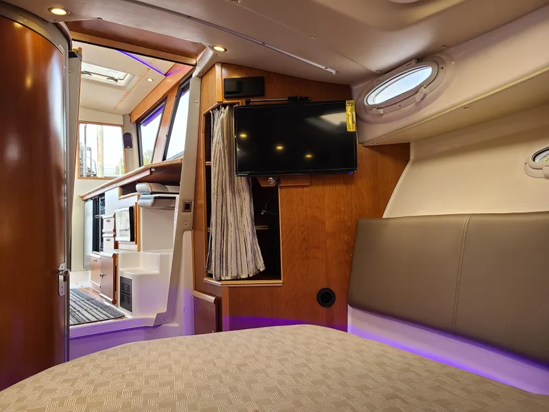 Slide: The Image of 2023 Cutwater C-30 Sedan NW Edition interior with modern amenities and cozy seating. - 19