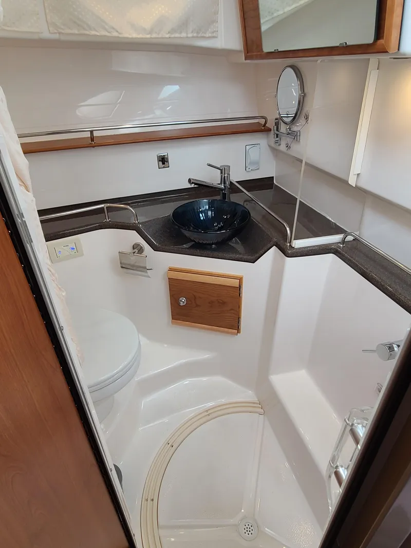 Slide: The Image of 2023 Cutwater C-30 Sedan NW Edition bathroom with modern fixtures and compact design. - 21