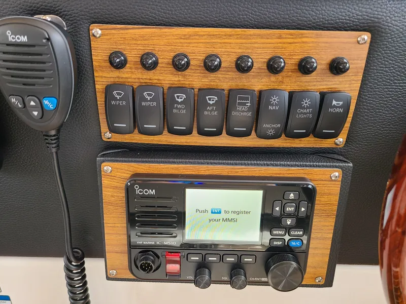 Slide: The Image of Control panel of 2023 Cutwater C-30 Sedan NW Edition with Icom radio and switches. - 23