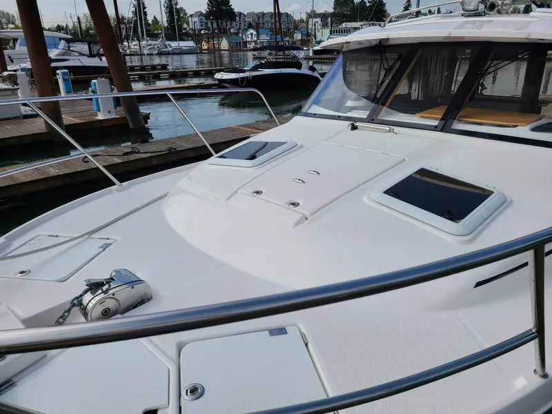 Slide: The Image of 2023 Cutwater C-30 Sedan NW Edition docked at a marina, showcasing sleek design and modern features. - 3