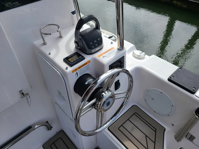 Slide: The Image of 2023 Cutwater C-30 Sedan NW Edition helm with steering wheel and controls. - 5
