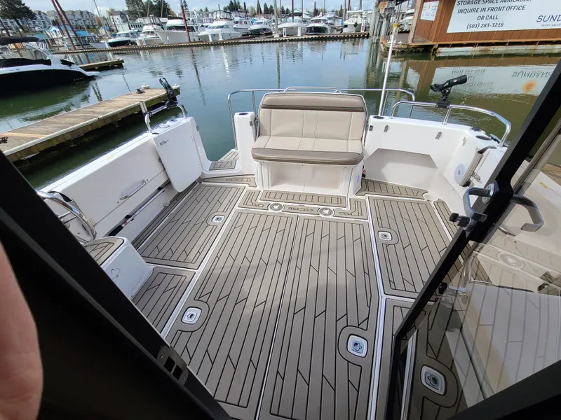 Slide: The Image of 2023 Cutwater C-30 Sedan NW Edition boat deck with seating, docked at marina. - 6