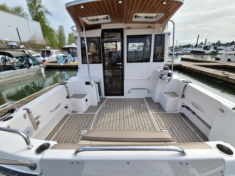 Slide: The Image of 2023 Cutwater C-30 Sedan NW Edition boat with spacious deck at marina. - 7