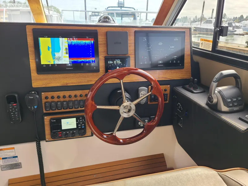 Slide: The Image of 2023 Cutwater C-30 Sedan NW Edition helm with advanced navigation displays and controls. - 9