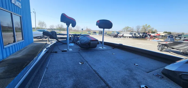 Slide: The Image of 2022 Ranger RT198P boat deck with seating and equipment, parked outdoors. - 4