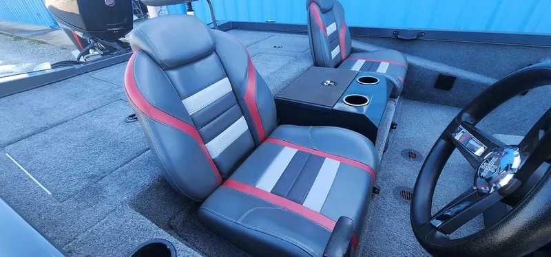 Slide: The Image of 2022 Ranger RT198P boat interior with gray and red seats, steering wheel, and cup holders. - 9