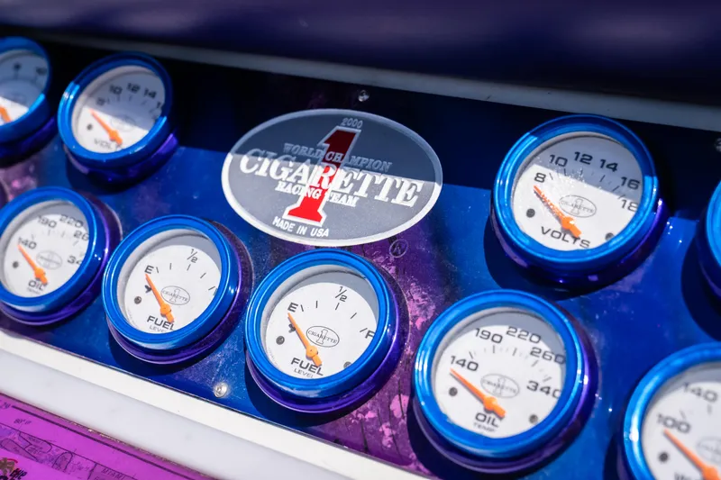 Slide: The Image of Dashboard of a 2000 Cigarette 38' Top Gun boat with gauges and logo. - 15