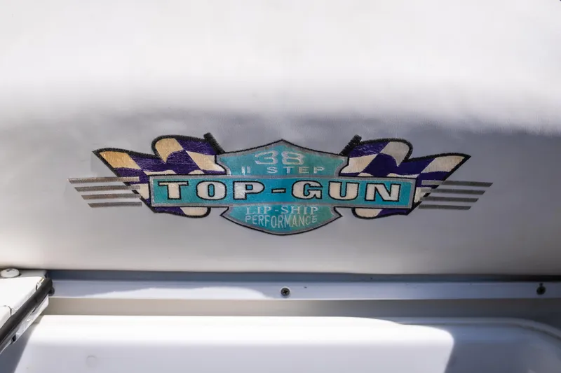 Slide: The Image of Cigarette 38' Top Gun 2000 logo on boat upholstery with racing theme. - 16
