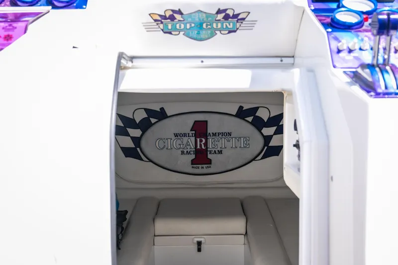 Slide: The Image of 2000 Cigarette 38' Top Gun boat interior with racing team logo and vibrant dashboard. - 17