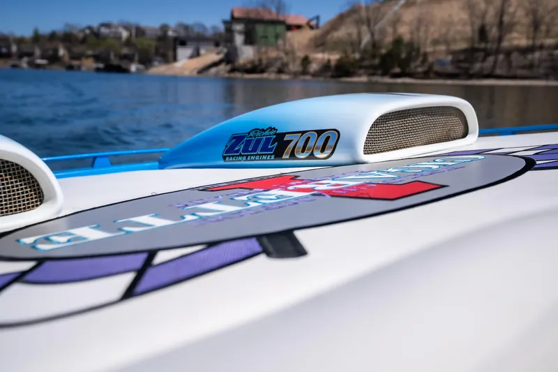 Slide: The Image of 2000 Cigarette 38' Top Gun boat with racing engine details on a sunny day. - 22