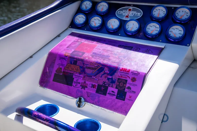 Slide: The Image of Dashboard of a 2000 Cigarette 38' Top Gun boat with gauges and vibrant purple accents. - 23