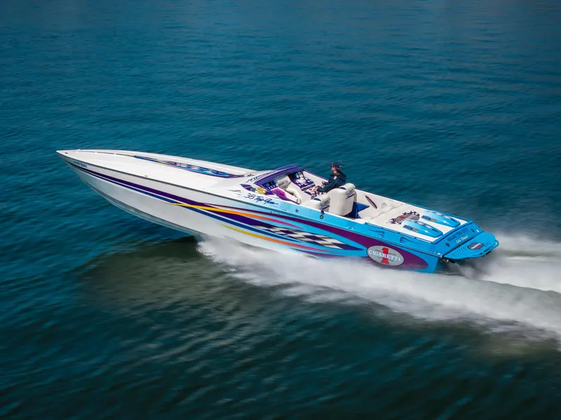 Slide: The Image of 2000 Cigarette 38' Top Gun speedboat cruising on open water. - 27