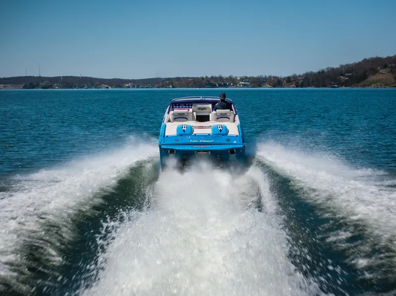 Slide: The Image of 2000 Cigarette 38' Top Gun speedboat cruising on a clear blue lake. - 29