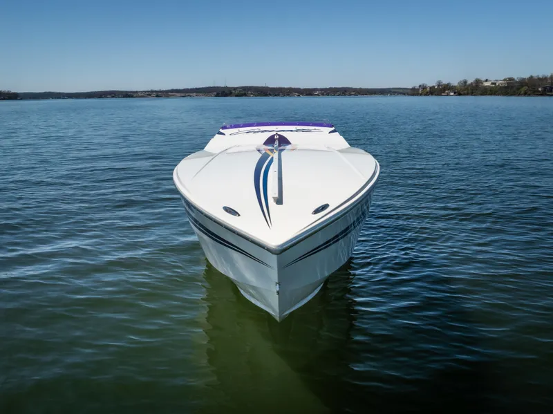 Slide: The Image of 2000 Cigarette 38' Top Gun boat on calm water, front view. - 3