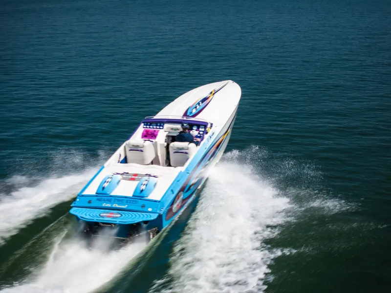 Slide: The Image of 2000 Cigarette 38' Top Gun speedboat cruising on open water. - 32