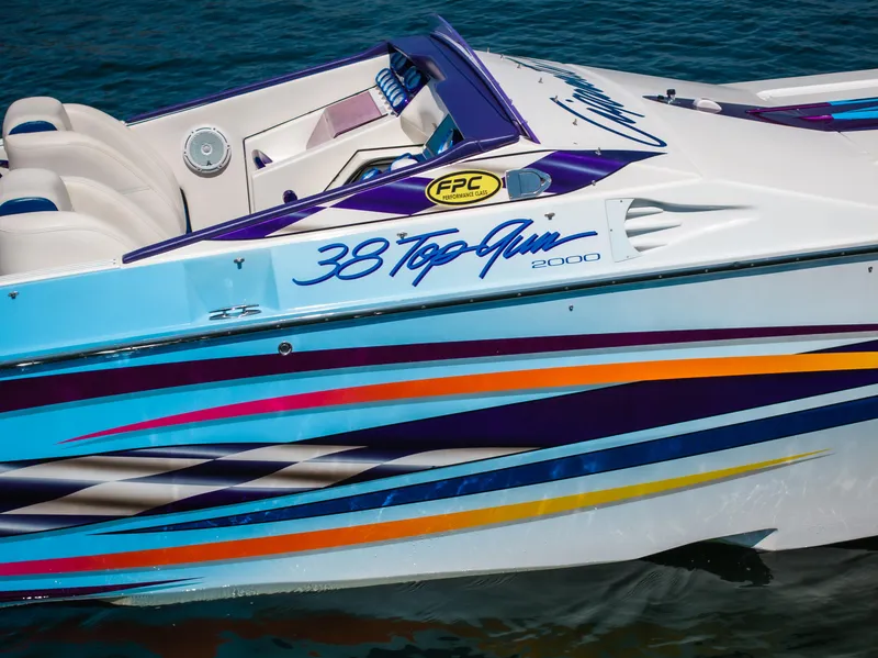 Slide: The Image of 2000 Cigarette 38' Top Gun boat with colorful graphics on water. - 4
