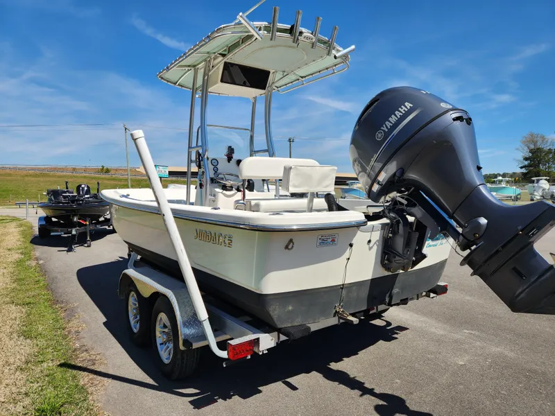 Slide: The Image of 2015 Sundance B20CCR boat on trailer with Yamaha outboard motor, parked on a sunny day. - 4