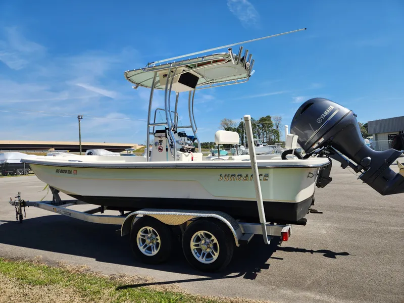 Slide: The Image of 2015 Sundance B20CCR boat on trailer with outboard motor, parked outdoors. - 5