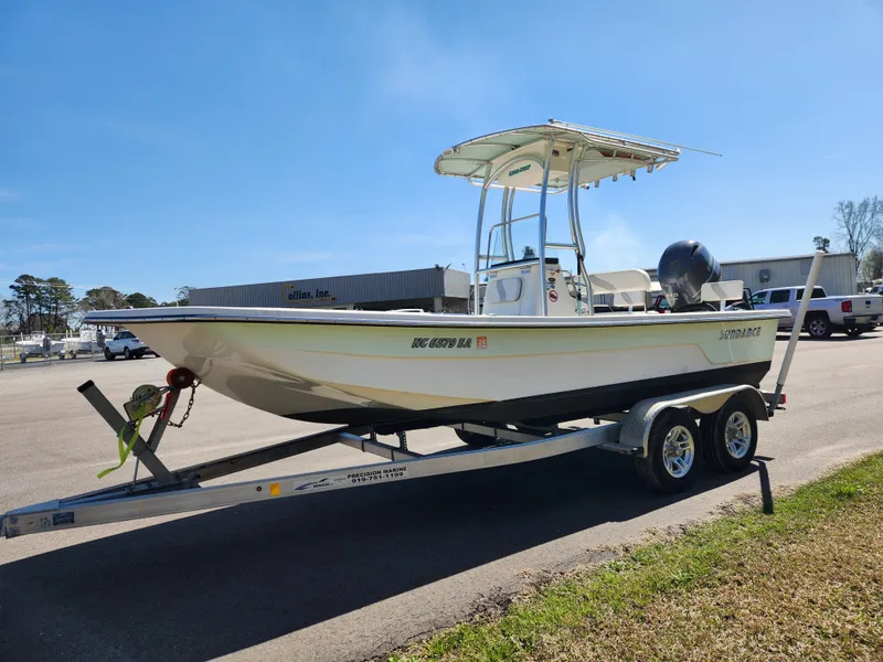 Slide: The Image of 2015 Sundance B20CCR boat on trailer, parked outdoors under clear blue sky. - 7
